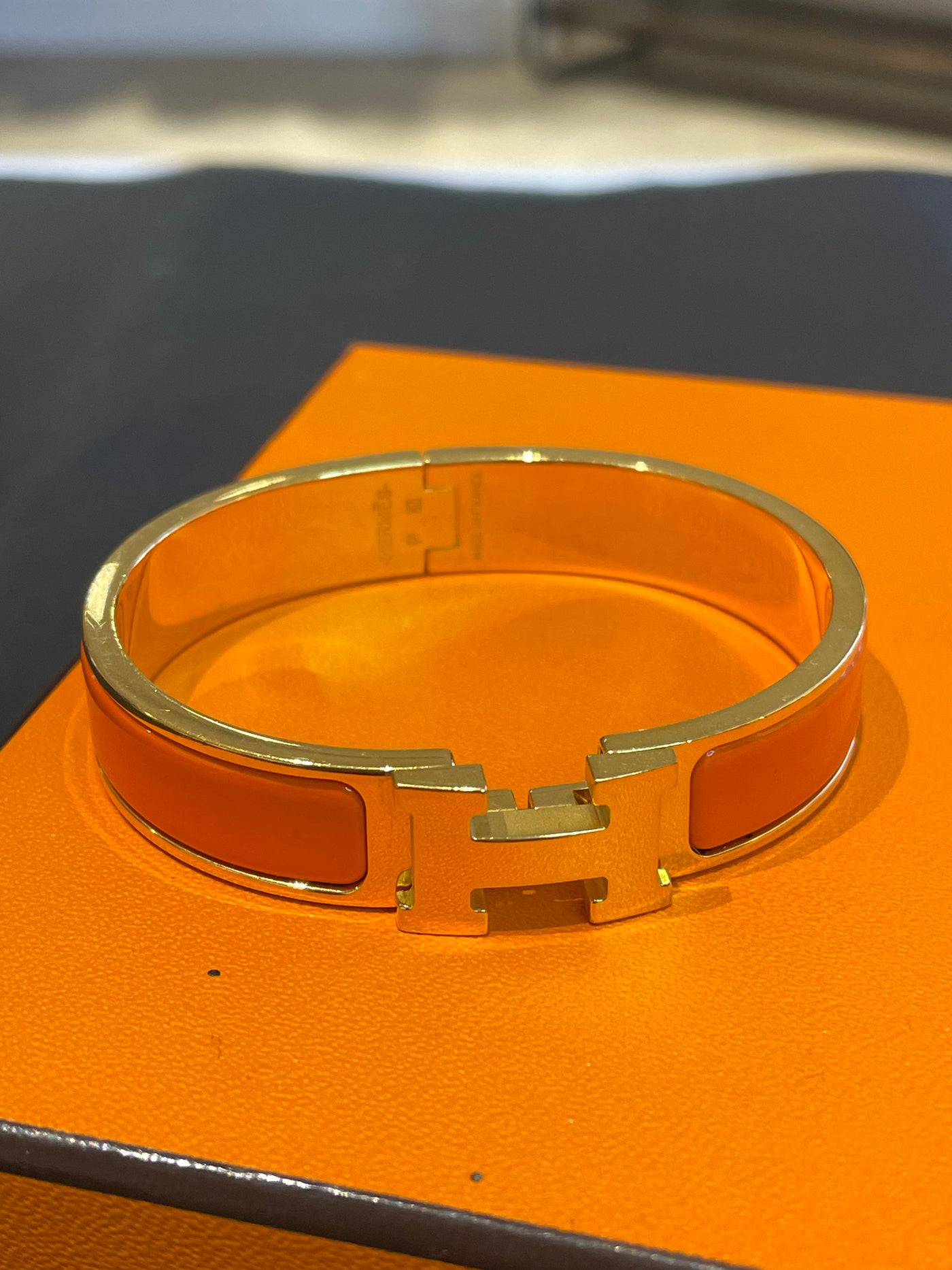 Hermes Enamel Narrow Clic Clac H Bracelet in orange RTP £560